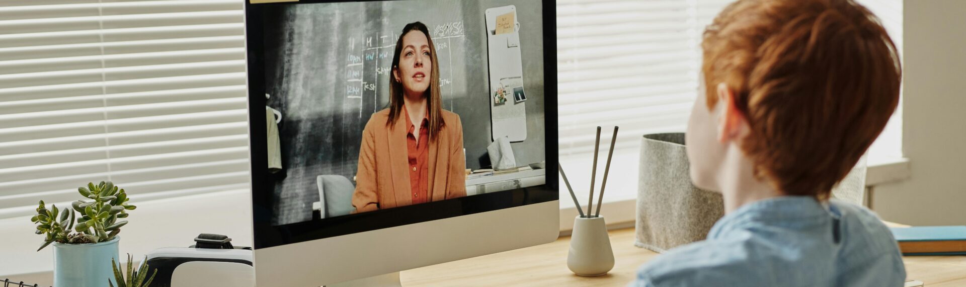 Teacher using AI-powered dashboard to personalise student learning in a modern classroom, representing the future of education in 2025.